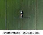A Tractor Spraying Controversial Glyphosate Herbicide onto Farmland Aerial View
