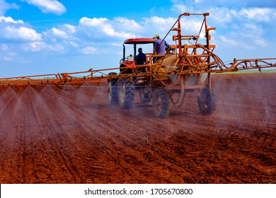 Tractor spraying freshly ploughed land for weeds