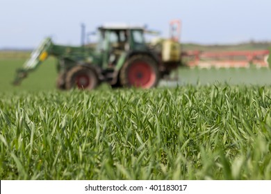 Tractor Spraying Green Field - Agriculture Background