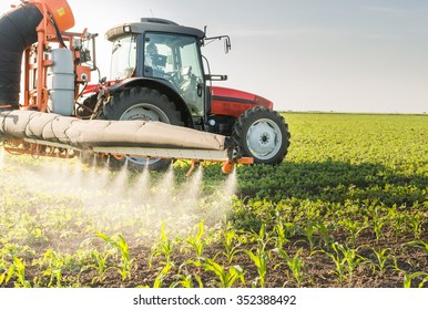 Tractor spraying pesticides on soy bean