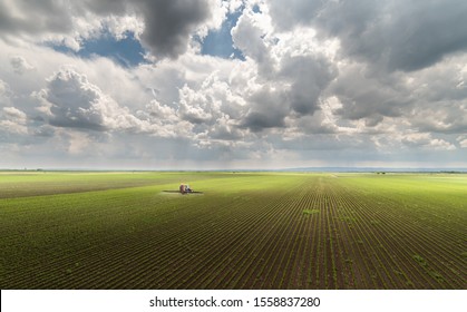 Tractor Spraying Pesticides On Soybean Field  With Sprayer At Spring