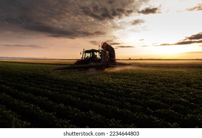 Tractor spraying pesticides on soybean field  with sprayer at spring - Shutterstock ID 2234644803