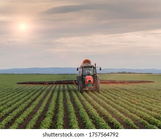 Tractor spraying pesticides at soy bean fields - Shutterstock ID 1757564792