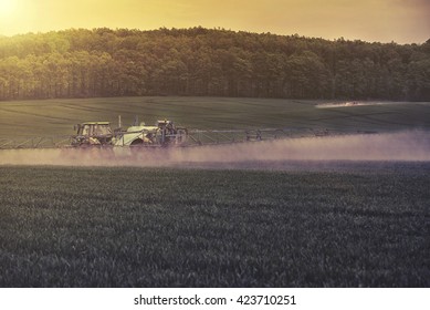 Tractor spraying soybean field at spring - Shutterstock ID 423710251