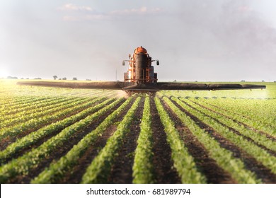 Tractor spraying soybean field at spring  - Shutterstock ID 681989794
