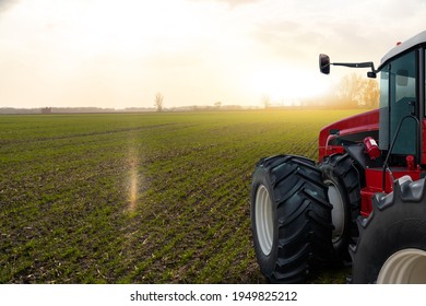 Tractor in a spring wheat field. - Shutterstock ID 1949825212