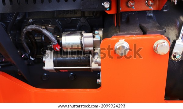 Tractor starter motor. Details of orange
tractor diesel engine starter. selective
focus