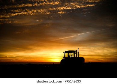 Tractor at Sunrise in Cornfield