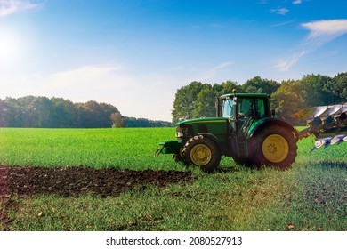 Tractor sunset. Agriculture farm machinery on landscape land field. Farmer machine equipment for crop. Combines harvesting concept