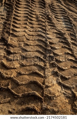 tractor tire pattern printed on red soil