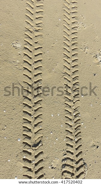 Tractor tracks in the\
sand