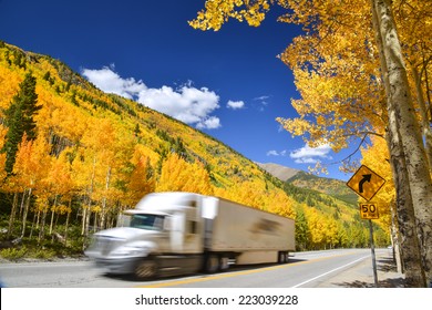 Tractor Trailer Truck Driving Along Colorado Highway On Colorful Autumn Day