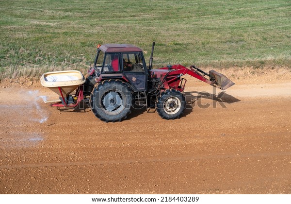 the tractor treats the chemistry of the autocross\
tracks before the races