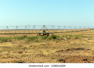 The Tractor Waters The Field With Water. Reclamation