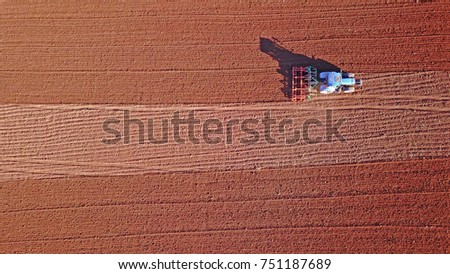 Similar – Combine harvester harvests a grain field in the evening light from the air