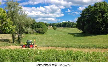 Tractor working fields in summer