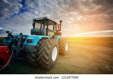 Tractor working on the farm, a modern agricultural transport, a farmer working in the field, tractor at sunset, modern tractor closeup - Shutterstock ID 1212477004