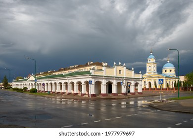 Trade rows - White shops and Alexander Nevsky Cathedral in Pruzhany city, Brest region, Belarus.