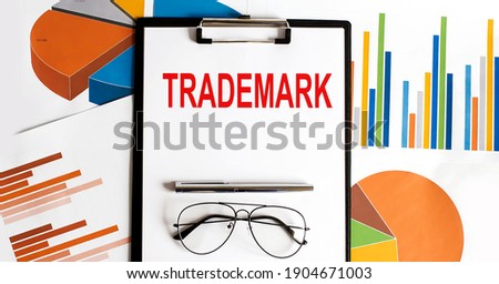 TRADEMARK . Conceptual background with chart ,papers, pen and glasses business