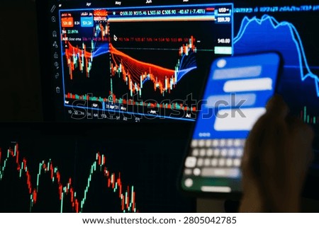 A trader or a financial analyst checking the recent stock exchange trends sending messages on the smartphone.