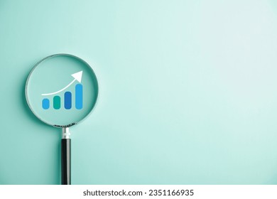 Trader hand wields magnifier glass for scrutinizing bar graph with ascending arrow. Analyzing technical stock market chart embodies the concept of business investment for potential growth and success.