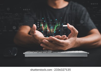 Trader or investor man presents a hologram of a growing stock chart on his palm in a close-up. Stock market data analysis, strategic planning, and business growth concepts. Empower your success. - Shutterstock ID 2336327135