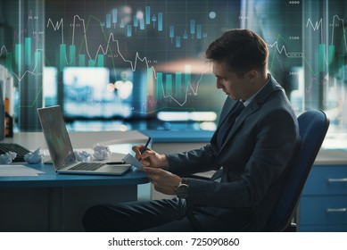 Trader, a player in the securities market on the Forex or Forbes. Elegant stylish successful in a suit in the office. On glass is large chart of the fall and increase in exchange rate of currencies