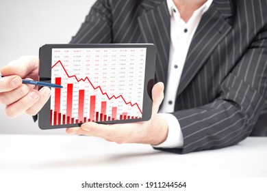 Trader Shows Correction Chart Tablet Screen. Concept Of Correction Stock Market Due To Trading Short Positions. Correction Of Share Prices Due Conflict With Private Investors. Stock Market Analysis