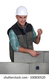 Tradesman Holding A Plumbline