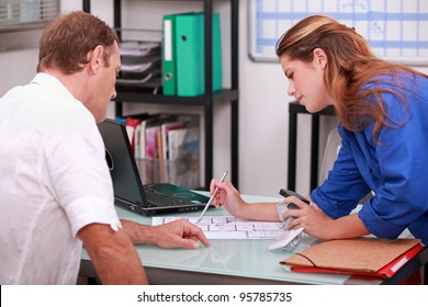 Tradespeople discussing a project - Powered by Shutterstock