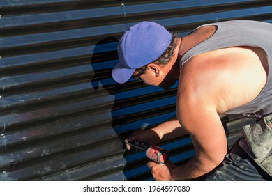 Tradie Working, A Contractor Using A Power Tool On Job Site