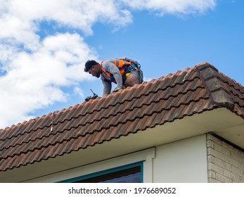 Tradie Working On Tile Roof. Auckland, New Zealand - May 13, 2021