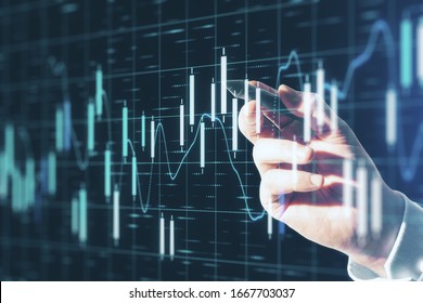 Trading concept with digital screen with bright graphs going up at business chart background and man hand pushing on screen by pen.