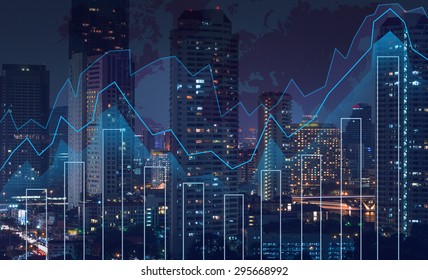 Trading graph on the cityscape at night and world map background,Business financial concept