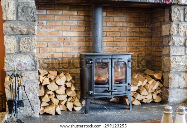 Tradional Wood\
Burning Stove in a Brick\
Fireplace