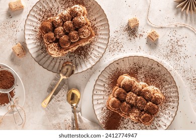 Tradition italian layered dessert tiramisu with mascarpone cream and ladyfingers biscuits sprinkled with cocoa powder on a white background. Top view