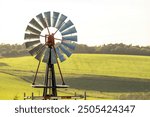 Traditional 18 blade rural farm water pumping windmill on galvanized metal tower