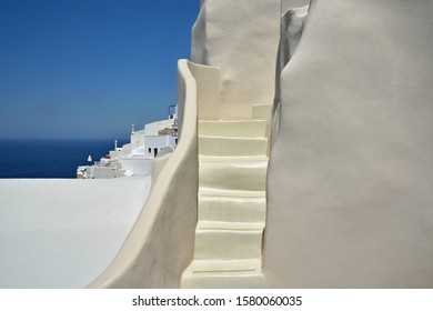 Traditional Adobe Style Steps And Whitewashed Houses Overlooking The Aegean Sea, In Oia Santorini Island, Cyclades Greece. 