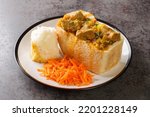 Traditional African bread based street food called Bunny Chow closeup on plate on the table. Horizontal
