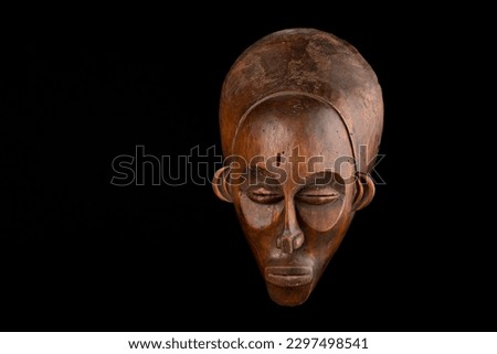 Traditional African mask against a black background