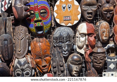 Traditional african masks hanging for sell in a market stall 