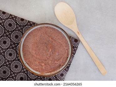 Traditional  African Sorghum breakfast porridge or Mabele, on mottled grey with copy space