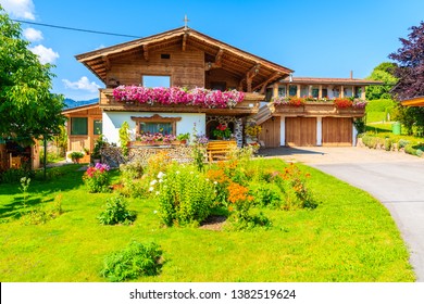 Traditional alpine house in village of Going am Wilden Kaiser on beautiful sunny summer day with Alps mountains in background, Tirol, Austria - Powered by Shutterstock