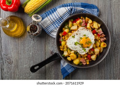 Traditional American hash with fried eggs. Top view. 