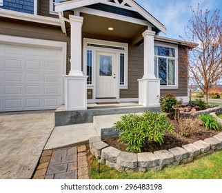 Traditional American Home With Nice Lawn And White Trim.