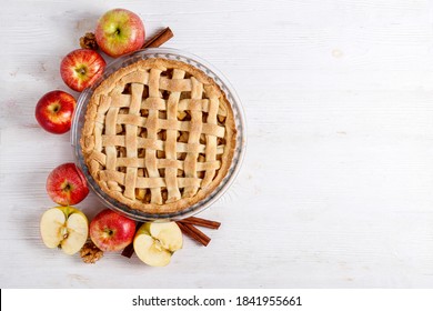 Traditional American Thanks Giving Pie, Whole & Halved Apples, Cinnamon Sticks, Anise Seeds. Homemade Fruit Tart Baked To Golden Crust With Ingredients. Close Up, Copy Space, Top View, Background.