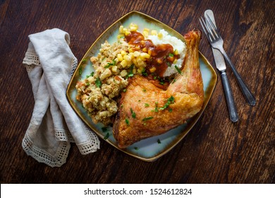 Traditional American Thanksgiving Dinner Plate With Crispy Baked Turkey Leg Mashed Potatoes Stuffing Gravy And Corn