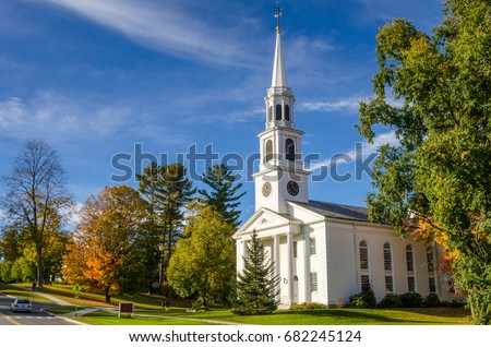 Traditional American White Church with high Steeple under an Autumnal Blue Sky. Williamstown, MA.
