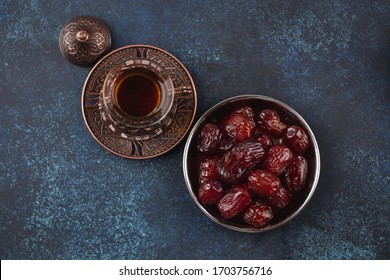 Traditional Arab Fresh Hot Tea With Dates From Above. Ramadan Snack Great For Iftar Or Suhoor Meal On Blue Rustic Background Top View. Arabian Sweet Treat 
