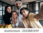 Traditional arabian family from Dubai spending time together at home. Concept about, emirati culture, parenthood, adoption and  family lifestyle